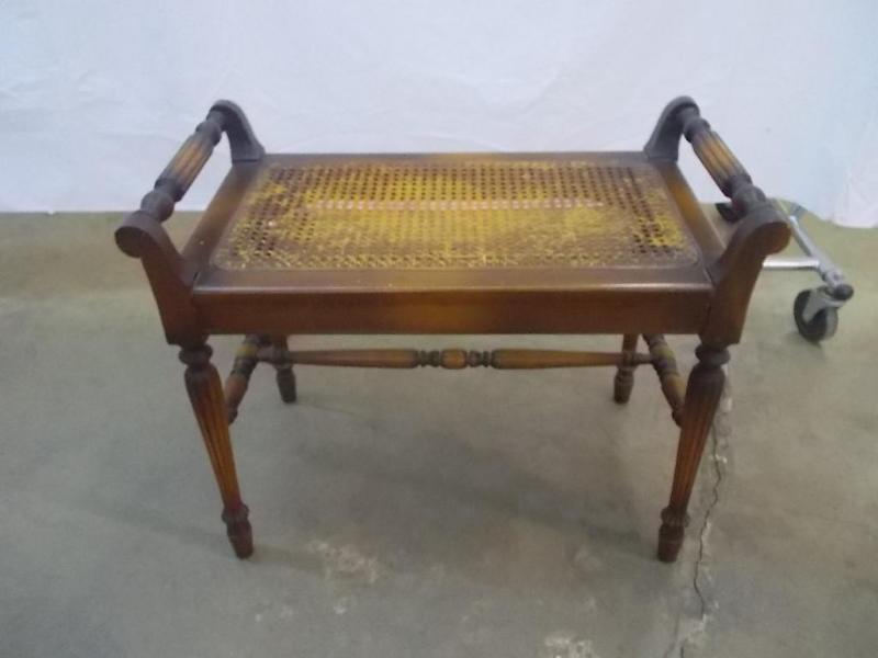 Cane seat bench with carved detaili...