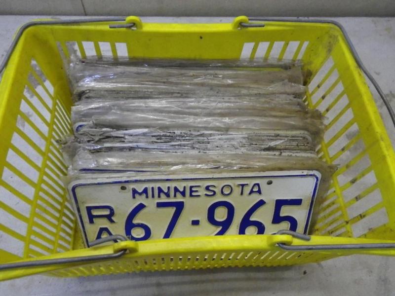 tote of license plates, look new...