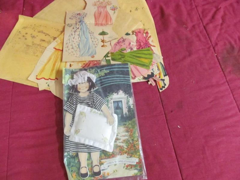 lot 121 image: Paper Dolls and Linnea Doll Clothes...