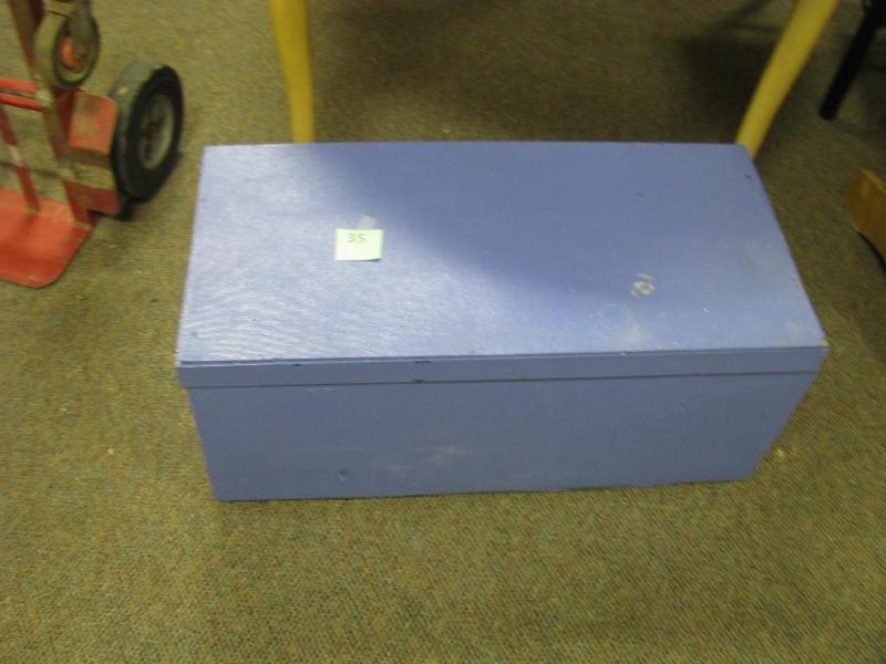 blue toy box with toys and books in...