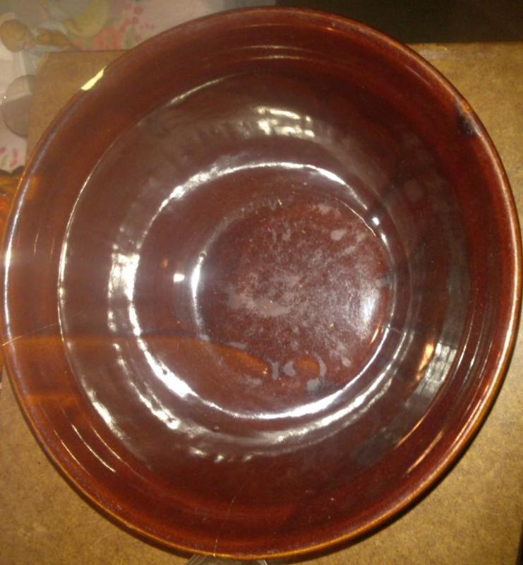 Vintage brown crock bowl, has a chi...