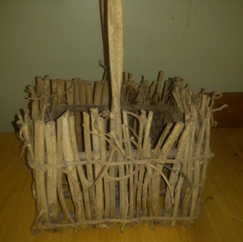 Handcrafted basket made of twigs, g...