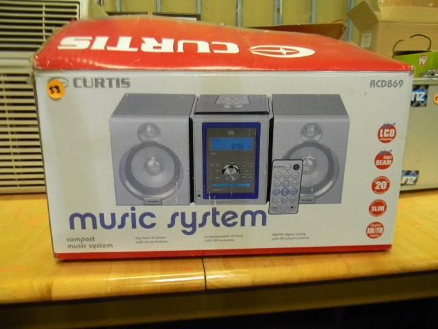 lot 53 image: Curtis music system in box...