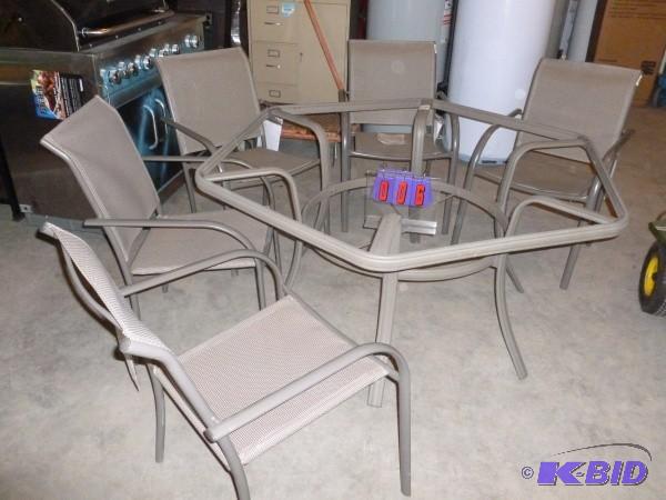 Patio set with 5 chairs. Appears to...