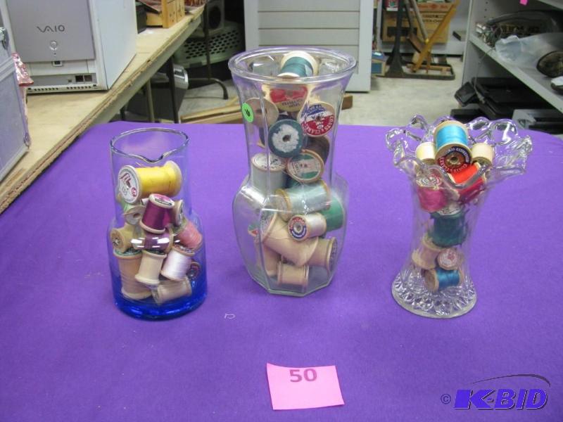 glass vases filled with wooden thre...