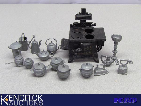 lot 100 image: Vintage Toy Cast Iron Stove and pewter Accessory Lot