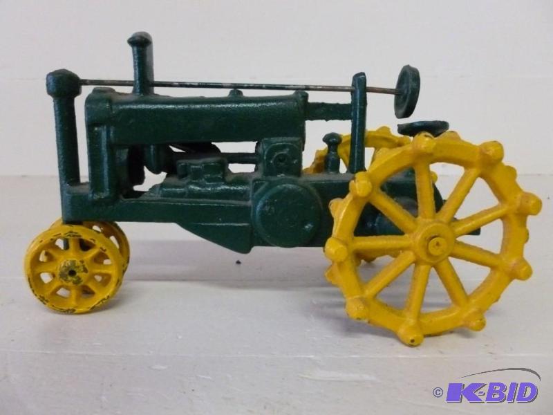 lot 25 image: Cast iron tractor that measures 4.5...