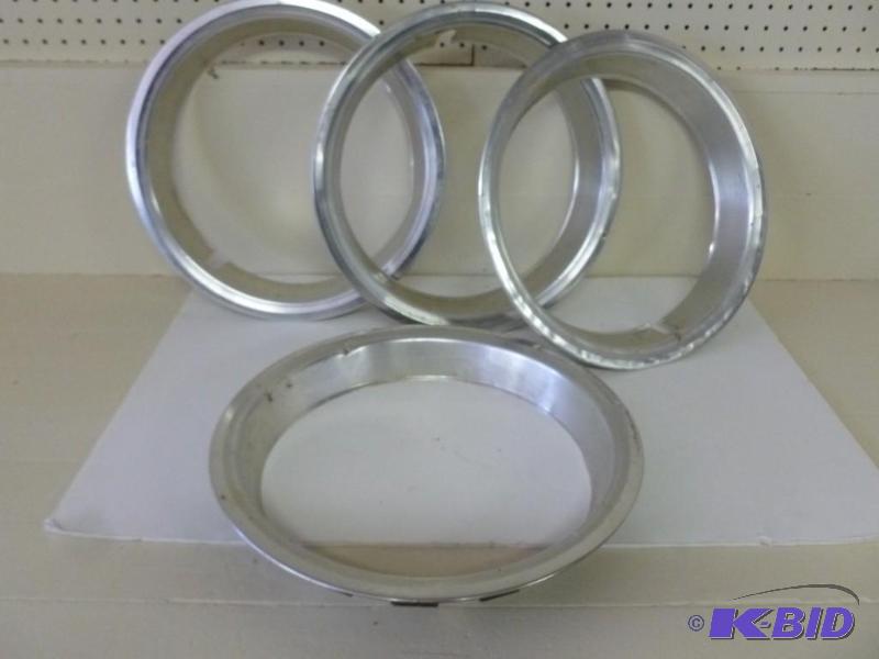 lot 42 image: A set of four aluminum car rim hubs...