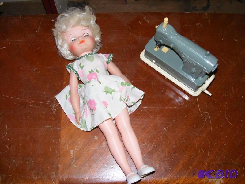 lot 23 image: Toy Doll and Toy Sewing Machine...
