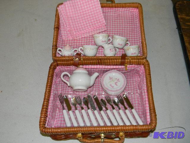 Lot of ceramic play dishes in picni...