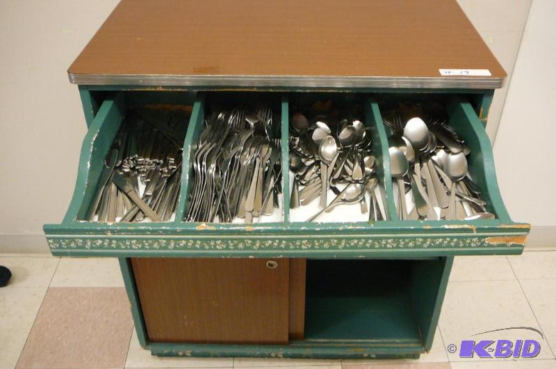 Silverware stand with lots of silve...