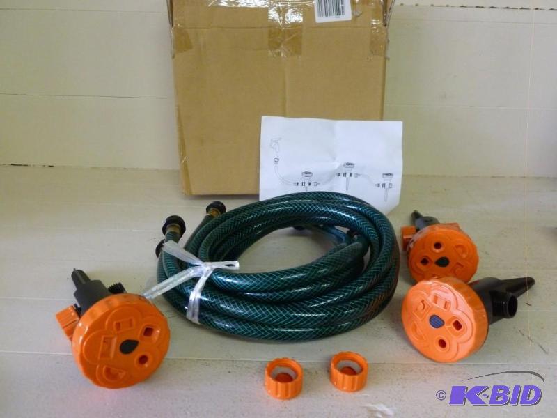 lot 42 image: Garden hose and three sprinkler hea...
