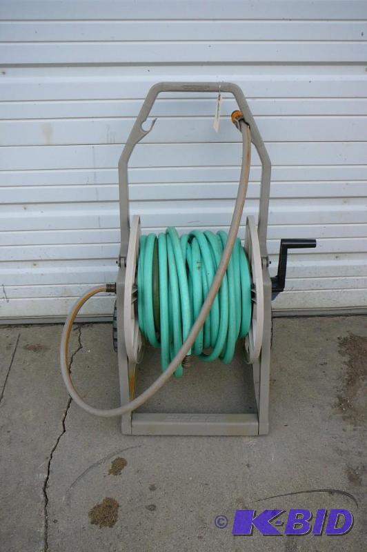 lot 21 image: Garden hose and reel 50ft long Sold...