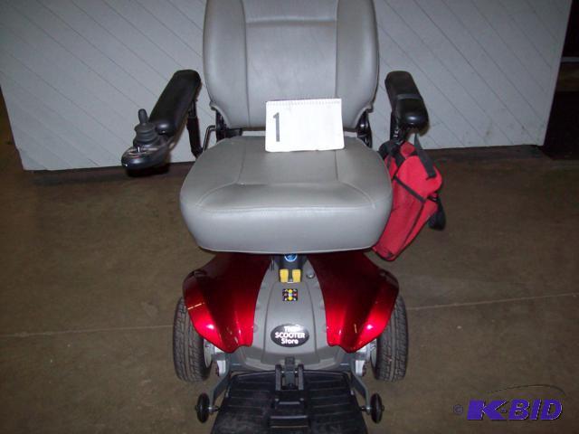 lot 1 image: Pride Mobility Powered Wheel Chair Model # TSS300