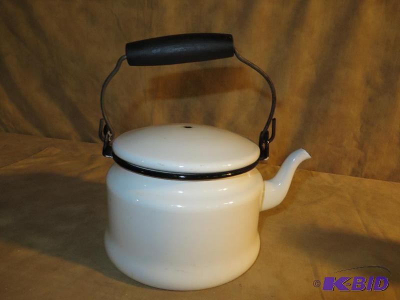 small white enamel tea pot with bla...