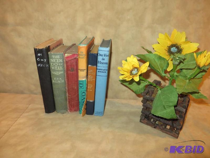Six vintage books and a sunflower. ...