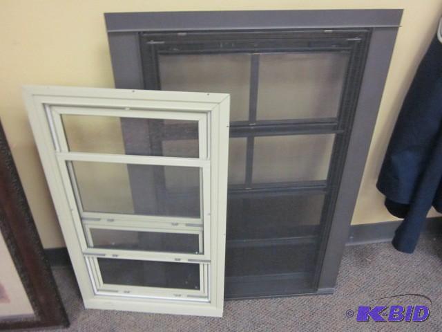 lot 104 image: Pair of aluminum storm windows, bro...