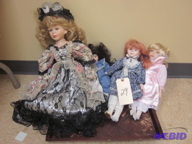 lot 29 image: (4) porcelain dolls and wood servin...