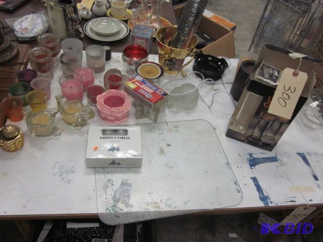 lot 300 image: Table of candles and related items....