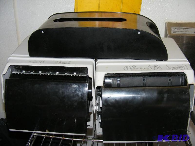 two white paper towel dispensers, a...