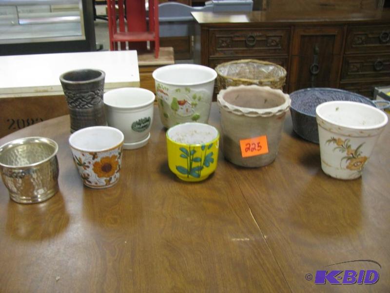 many ceramic and metal pots and pla...