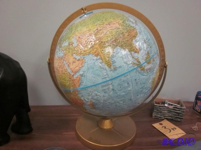 Vintage metal based globe with rais...