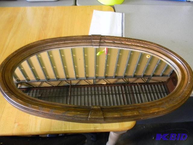 Mirror with plastic wood-looking fr...