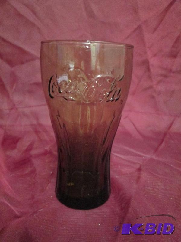 lot 16 image: Brown tinted Coca-Cola glass....