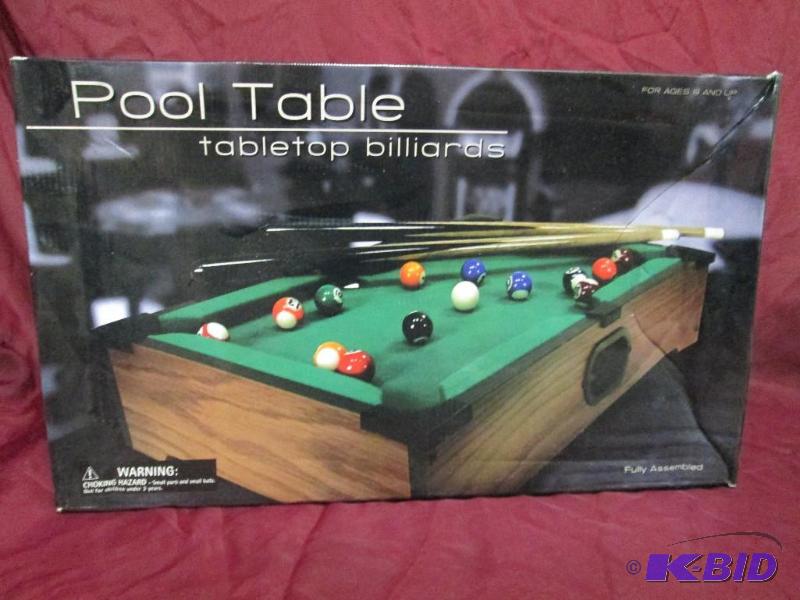 lot 19 image: Table top pool table with 2 cues. F...