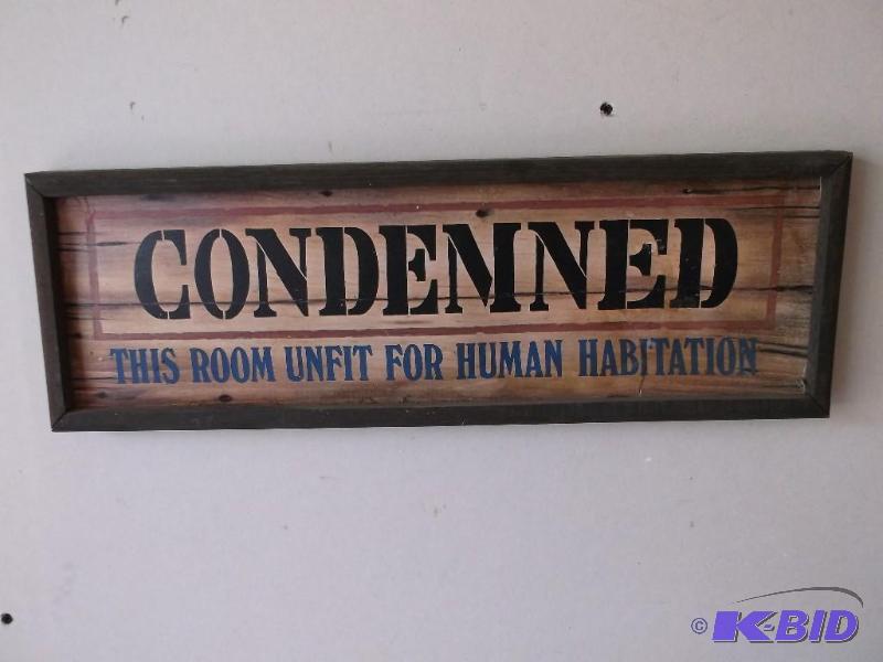 Wood framed sign Condemned has a li...