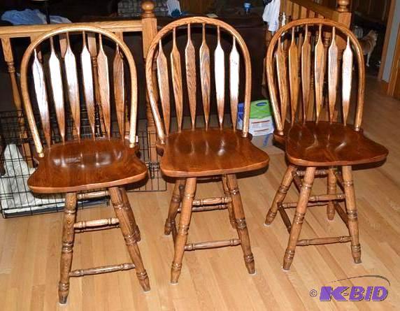 lot 6 image: Three study wood bar stools that sw...