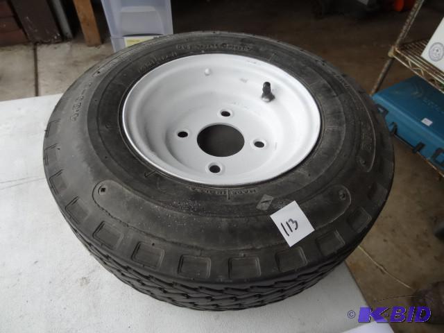 lot 113 image: Spare boat trailer tire. 4 hole rim...