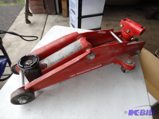 lot 56 image: Big red 2 ton trolley jack...