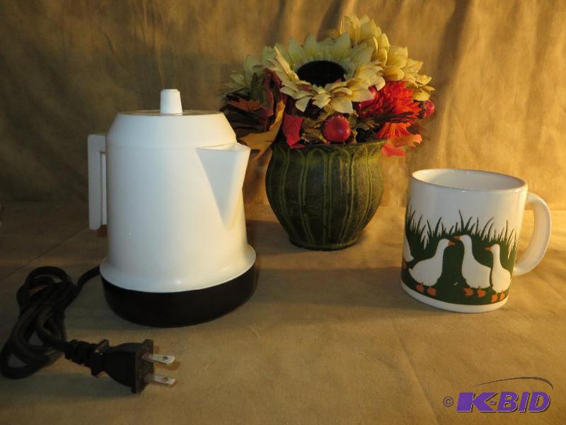 Small Electric Coffee Pot with a Cup made in West Germany and a bunch of flowers
