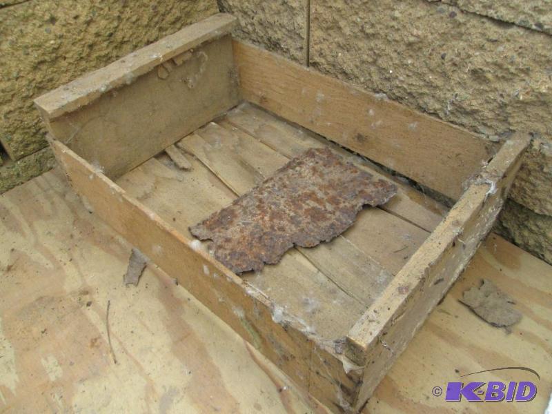 Wood crate with rusted licence plat...