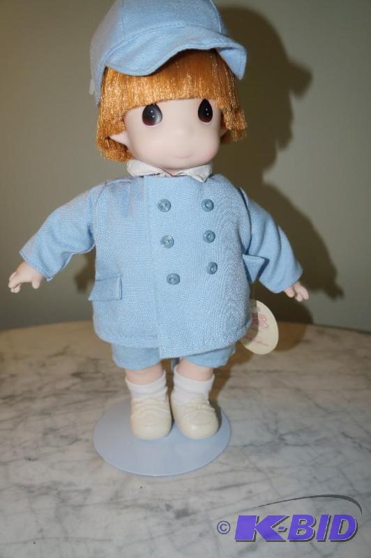 lot 19 image: Clifford 1994 Precious Moments Doll with Stand and Original Tags
