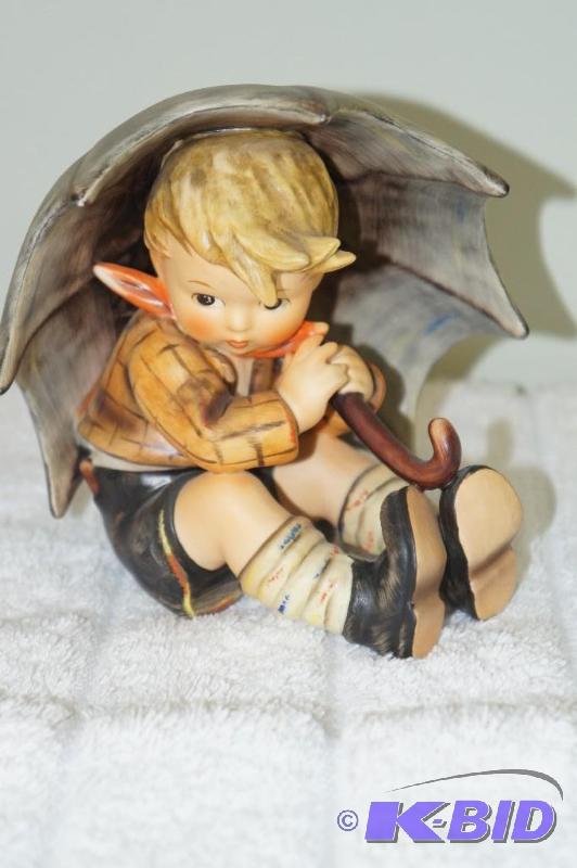 lot 251 image: Umbrella Boy Date Stamped 1957 M.I. Hummel Figurine