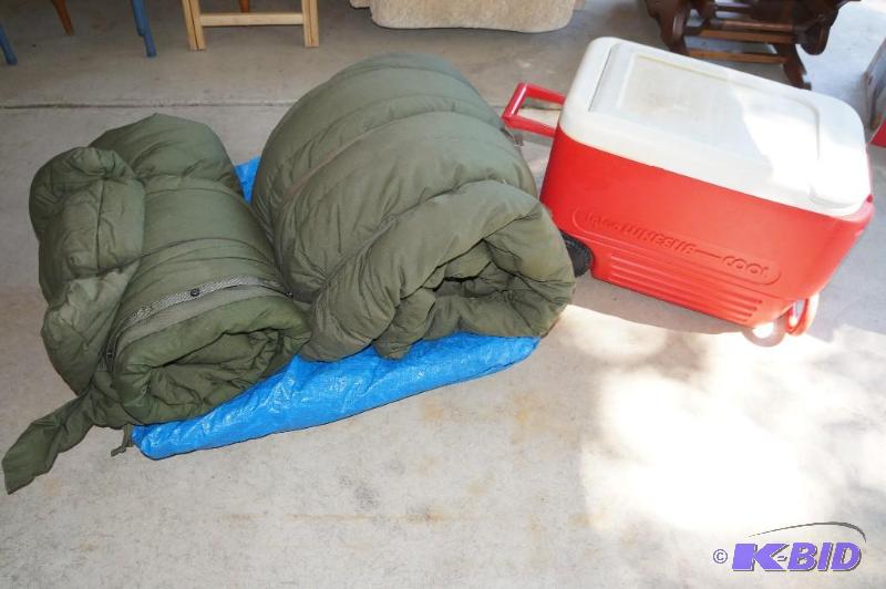 lot 13 image: Lot of 2 Military Sleeping Bags, a Cooler on Wheels and a Large Tarp