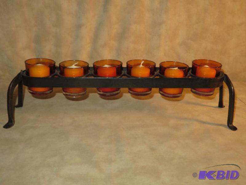lot 8 image: 6 FIRE ORANGE GLASS CANDLE HOLDERS IN A WROUGHT IRON STAND