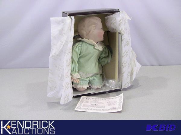 lot 59 image: New in Box Porcelain Knowles Yolandas Picture-Perfect Babies Jessica Doll  with COA