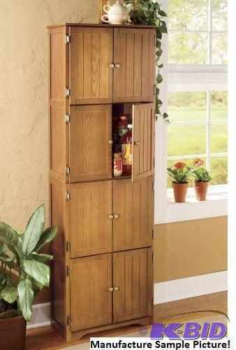 lot 1 image: Oak Finish Eight Door Pantry Cabinet -&nbspF...