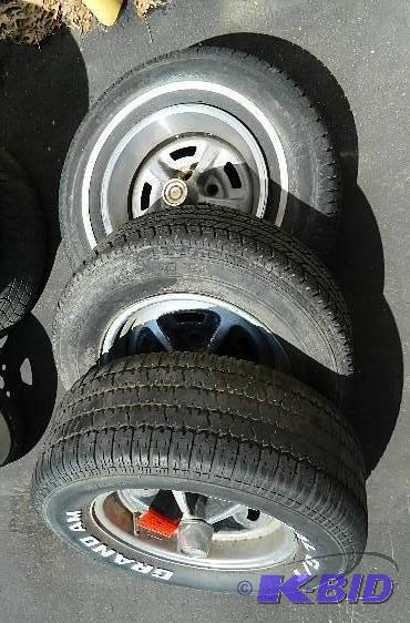 lot 34 image: (3) tires on Pontiac 14" rims. Please se...