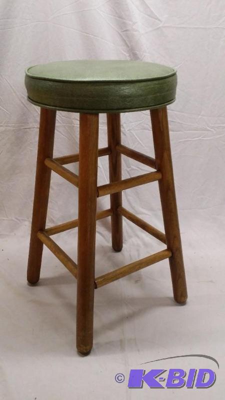 lot 7 image: Green cushion seat bar stool with wooden legs...