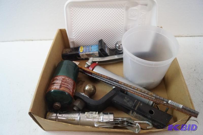 bolts, hitch, paint tray caulking gun, and a grease gun