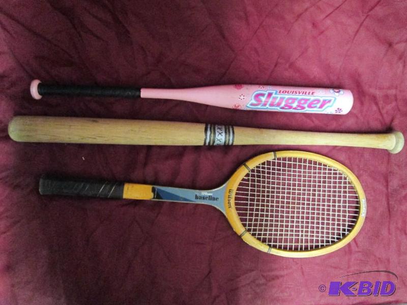 Tennis racket and a pair of bats. Pink bat is...