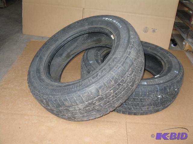 2 tires, P21565R15, half tread or better...
