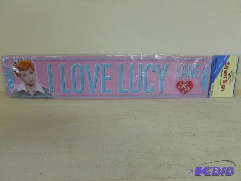 lot 115 image: I Love Lucy embossed metal sign that measures...