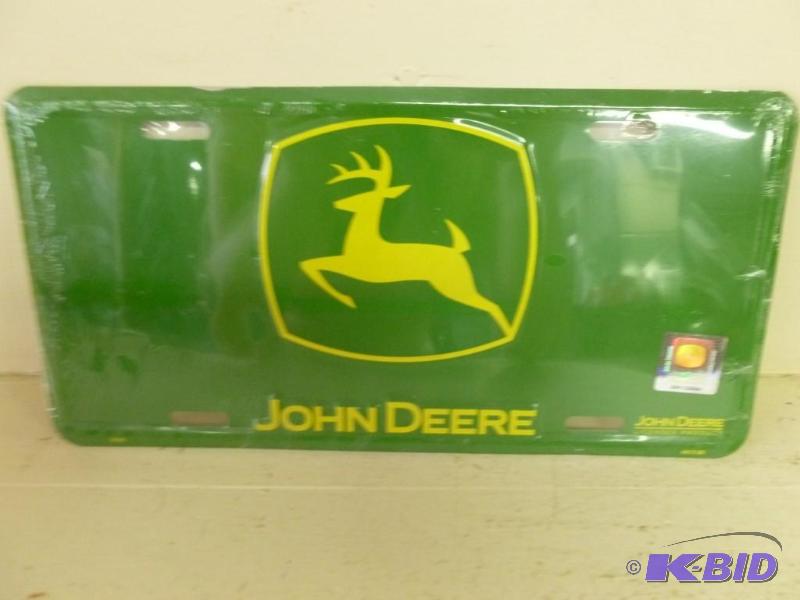 lot 129 image: John Deere embossed metal license plate that ...