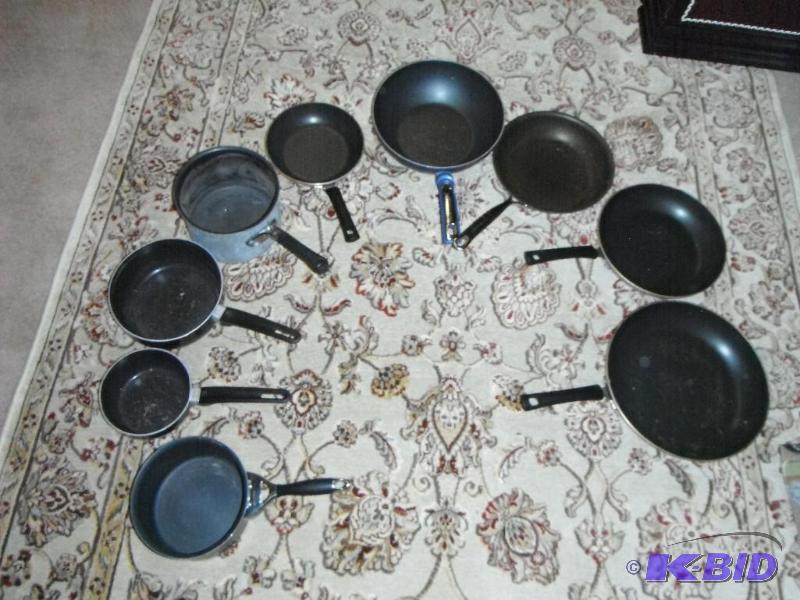 lot 27 image: A Collection of Nine Kitchen Pans and Pots...