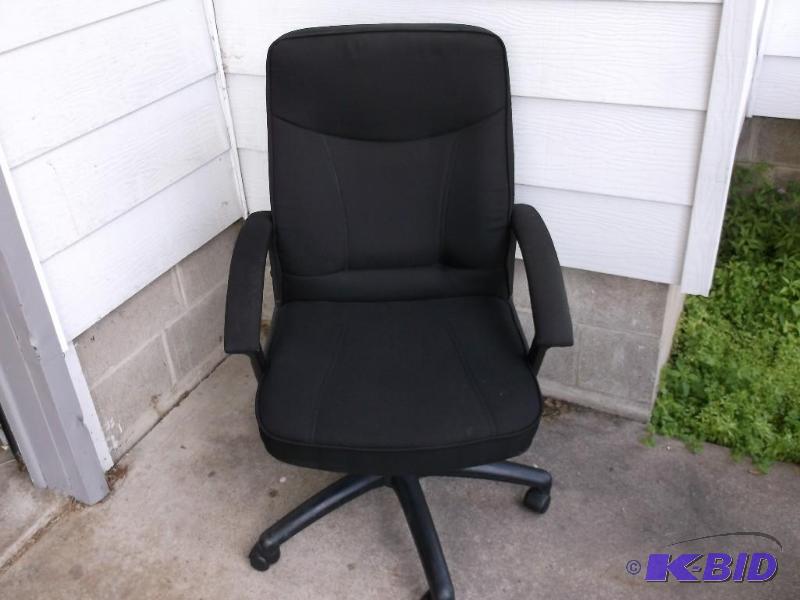 Black cloth office chair on wheels with seat ...
